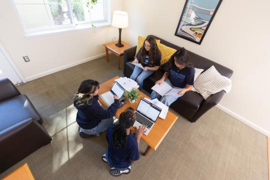 Group of students studying in a living room