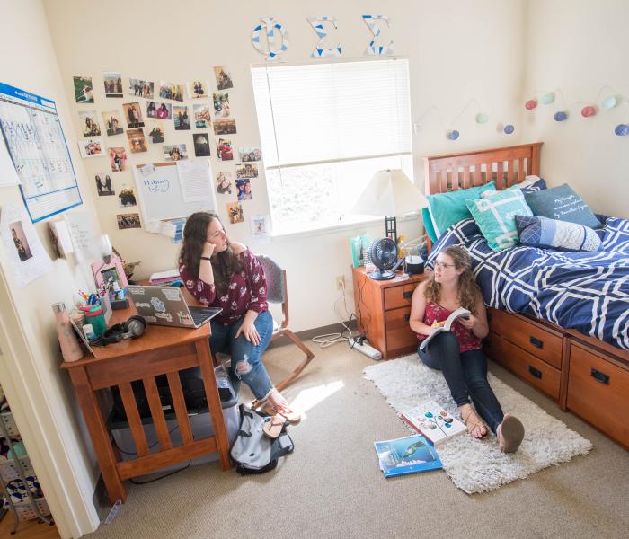 two students sitting in dorm room