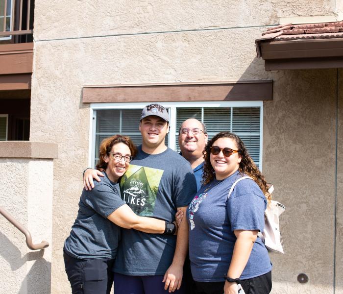Student with parents hugging 