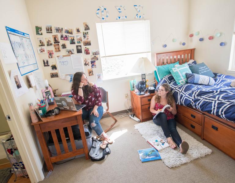two students sitting in dorm room