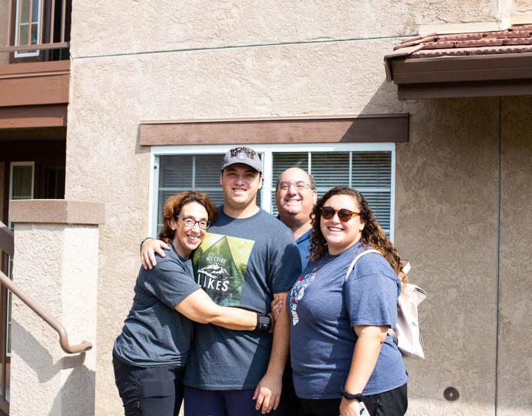 Student with parents hugging 