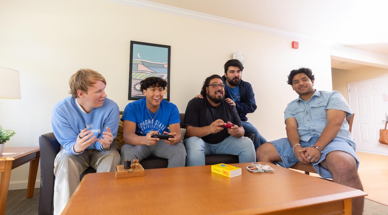 Group of students socializing in a living room