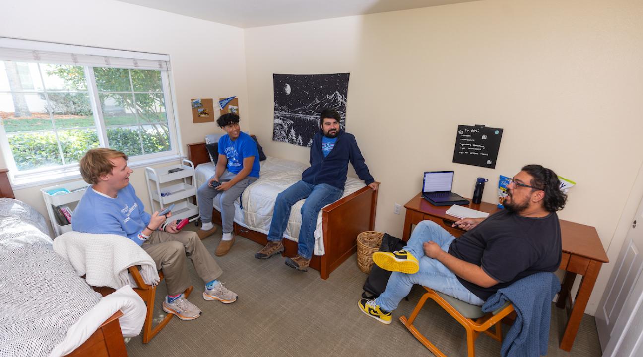 Group of student socializing in a dorm room