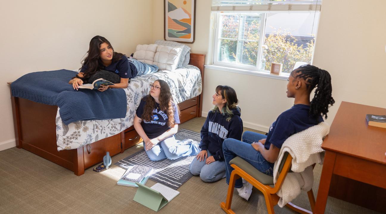 Group of student socializing in a dorm room