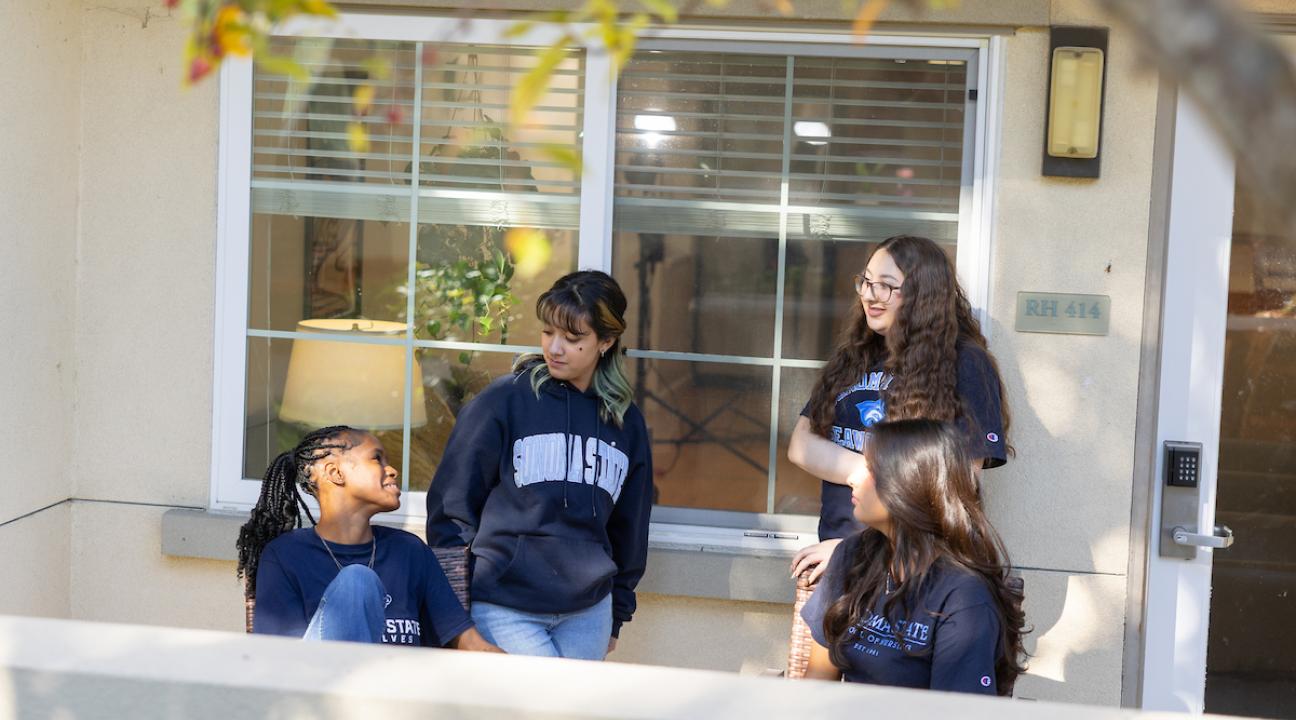 Group of students hanging out on a patio