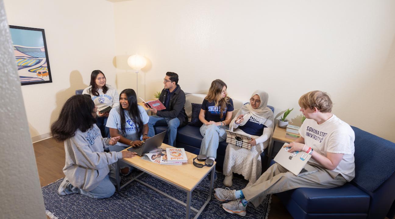 Students sitting in a living room socializing