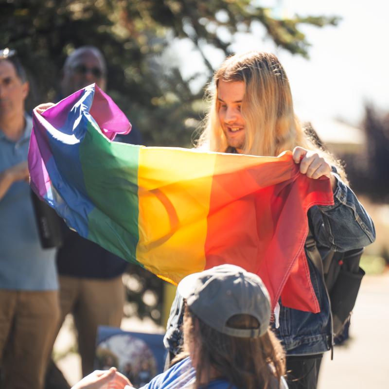 Student holding pride flag 