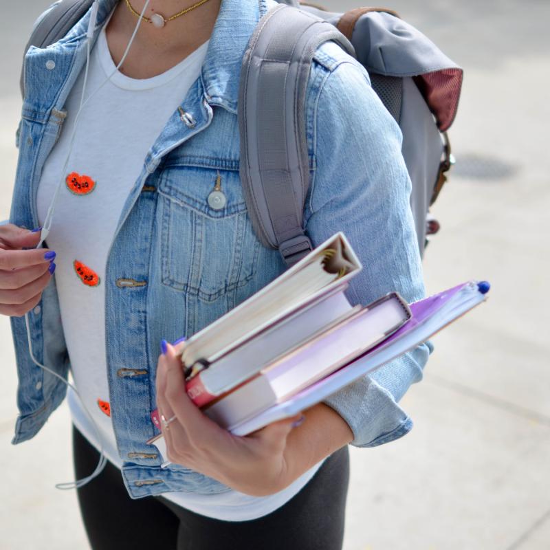 Person holding textbooks