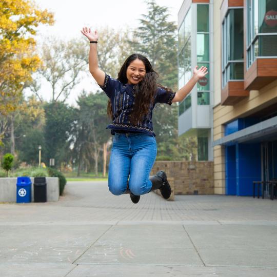 student jumping happy