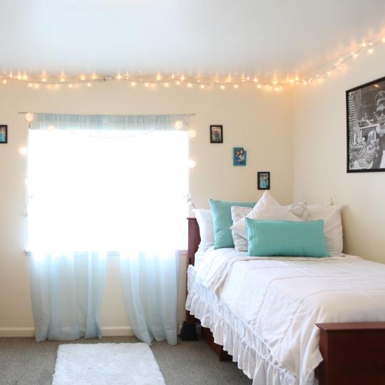 Dorm Room Interior with white bedspread