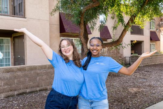 Two people holding up arms in excitement