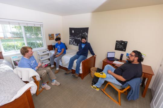 Group of student socializing in a dorm room