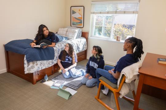 Group of student socializing in a dorm room