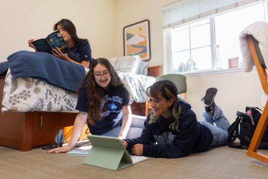 Students hanging out in bedroom together 
