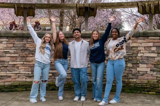 students together with hands in the air